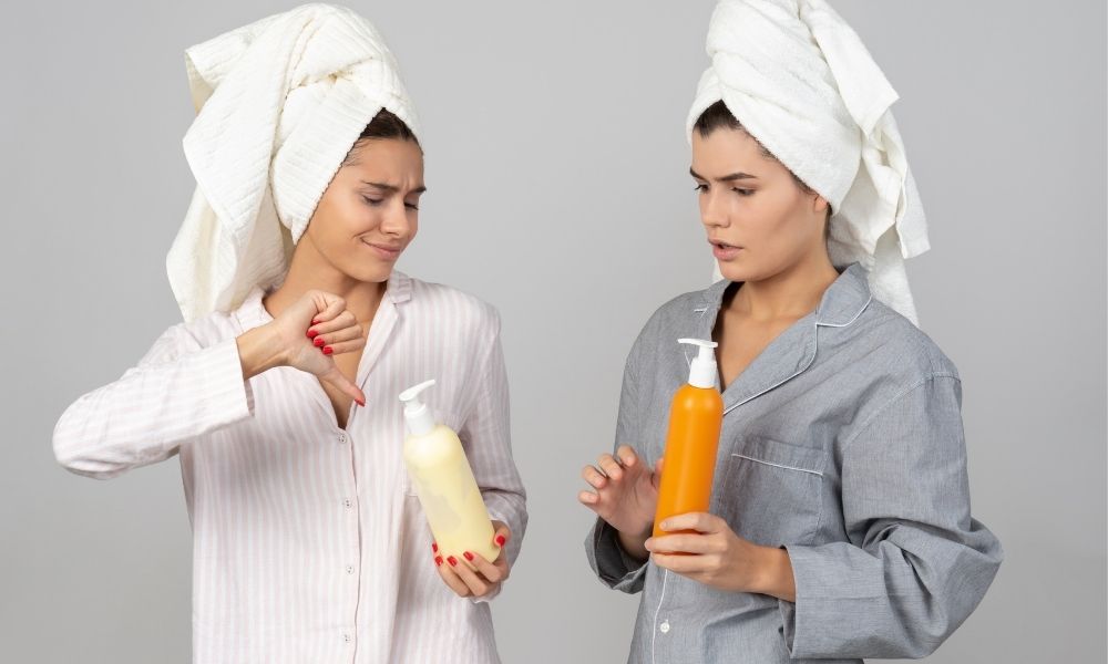 two women holding and judging bottles of lotion one